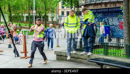 Belfast County Antrim May 04 2026 - Three workmen heading back to work wearing hi -viz jackets after having a lunch break in Belfast City centre Stock Photo