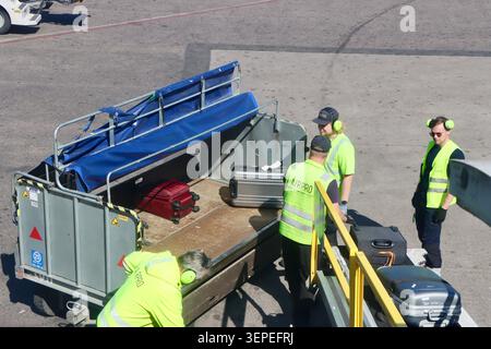 Airpro staff loading luggage into a SAS, Scandinavian Airlines plane at Helsinki airport, June 2026 Stock Photo