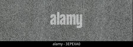 Asphalt road surface creating a textured background with dark gray tones Stock Photo