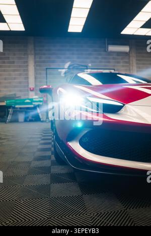 Ferrari 296 GTB front left quarter in workshop with LED headlamp flare Stock Photo
