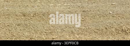 Dry sand and small rocks creating a textured natural background Stock Photo
