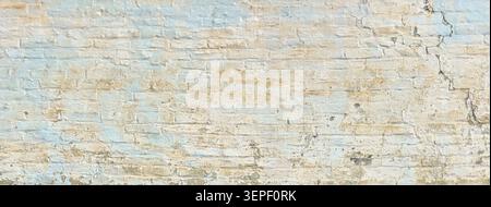 Old brick wall showing peeling paint, cracks, and grunge for background or overlay Stock Photo