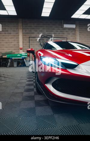 Ferrari 296 GTB front left three quarter view in modern workshop Stock Photo