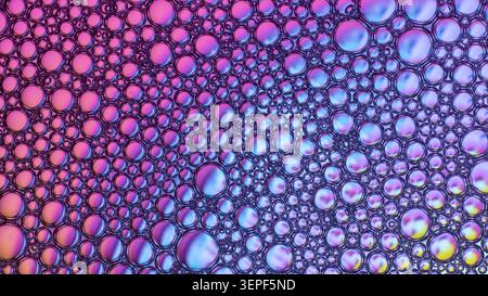Abstract background showing colorful gradient soap bubbles on a liquid surface Stock Photo