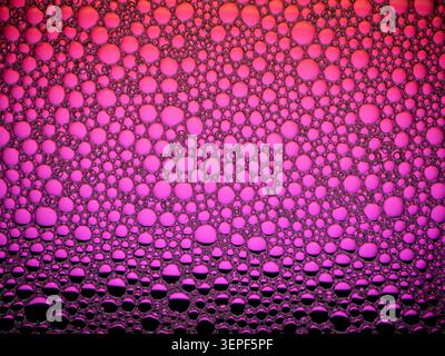 Soap foam pattern creating a vibrant pink and magenta abstract background Stock Photo