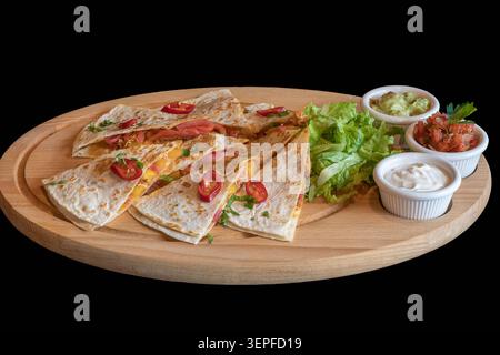 Pita stuffed with vegetable and meat mixture. Garnished with peppers. The dish includes vegetable, avocado and garlic dip in white bowls. The food is Stock Photo