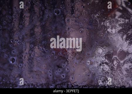 A structure resembling a bubbly or porous surface in shades of purple and violet. Background photo Stock Photo