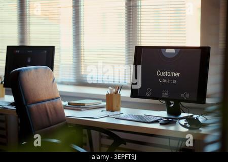 Office workstation displaying customer call interface, supporting call center service, client communication, remote assistance. Ideal for customer support, CRM, help desk marketing Stock Photo