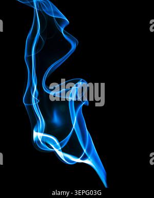 Elegant blue smoke ribbon flowing against a black background. Abstract smoke pattern with smooth curves and luminous appearance, ideal for backgrounds Stock Photo