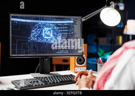 Arabian professional monitoring a futuristic network, ensuring cybersecurity while expert in artificial intelligence and machine learning, he utilizes a supercomputer for efficient data management. Stock Photo