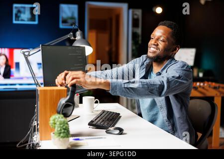 Systems manager developing computer commands for servers and coding in programming language while technical expert typing binary code in HTML terminal window, improves database cybersecurity. Stock Photo