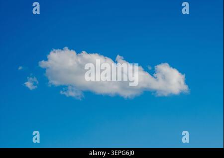 Fluffy White Cloud In Bright Summer Sky Stock Photo