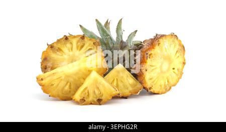 Fresh ripe pineapple sliced into rounds and wedges with leafy crown on a clean white background, highlighting juicy texture, vibrant color and tropica Stock Photo