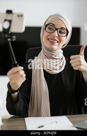 Woman Vlogging with Selfie Stick Stock Photo