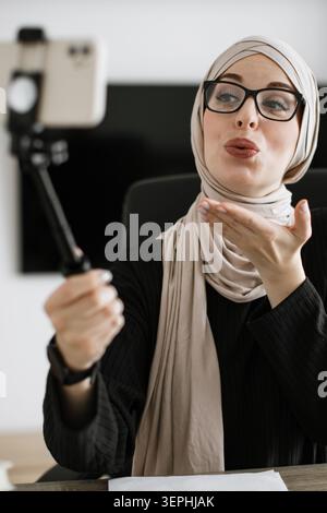 Woman Vlogging with Selfie Stick Stock Photo