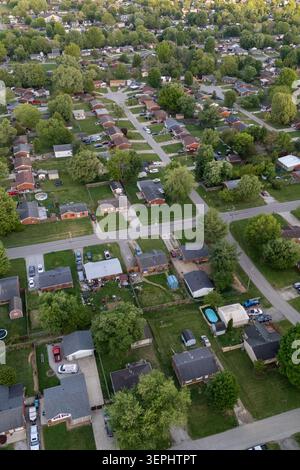 Aerial view of a quiet city street illuminated by streetlights at night ...