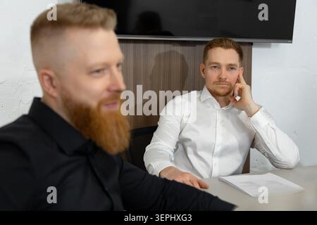 Businessman listening attentively during corporate meeting in office Stock Photo