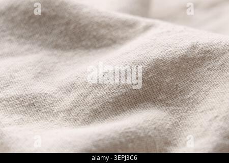 Soft beige fabric with subtle texture and gentle folds. Warm tones Stock Photo