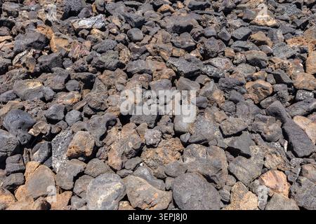 Close-up of volcanic lava rocks on Hawaii’s Big Island, creating a rugged natural texture and abstract geological backdrop formed by ancient lava flow. Stock Photo