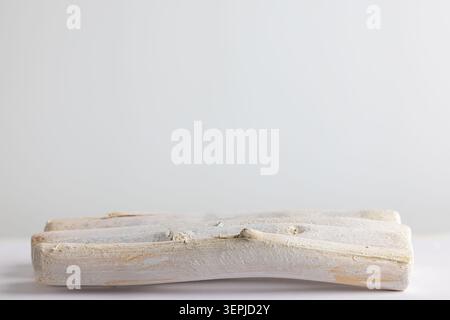 Empty rustic white wooden tray on pale surface with wide copy space for minimalist spa product display Stock Photo