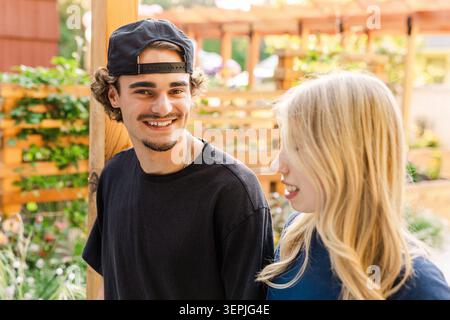Happy friends talking outdoors in summer Stock Photo