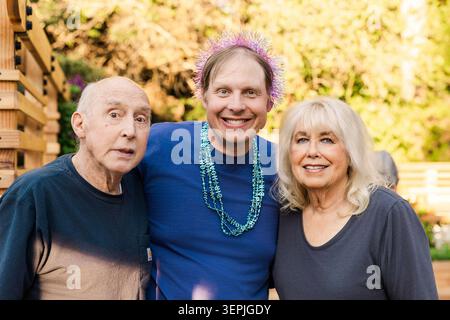 Happy middle aged man with older parents Stock Photo