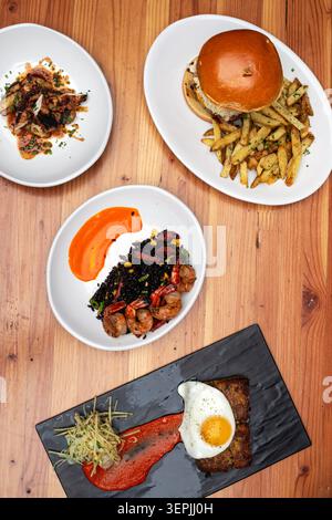 A flat lay of various gourmet restaurant plates on a table Stock Photo