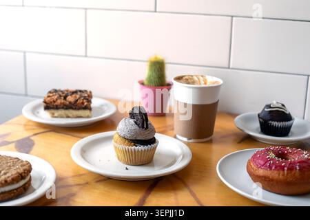 Assorted pastries and coffee on a cafe table Stock Photo