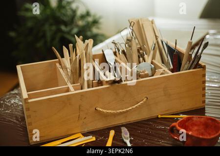 Ceramic Tool Set in Wooden Box on Studio Table Stock Photo