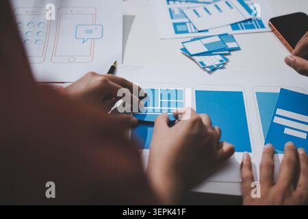 UI designer and UX developer brainstorm idea to design the application appearance in the early stage. Creative digital development agency. UX UI conce Stock Photo