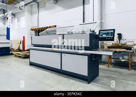 Busy furniture workshop with machines and tools in action Stock Photo