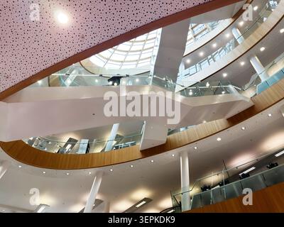 Liverpool, UK - May 16, 2026: Bright contemporary Central Library atrium featuring skylight, curved balconies, glass balustrades and wood accents in L Stock Photo