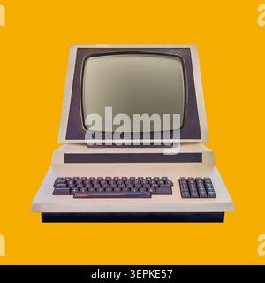 Vintage eighties desktop personal computer with crt display on an orange background Stock Photo