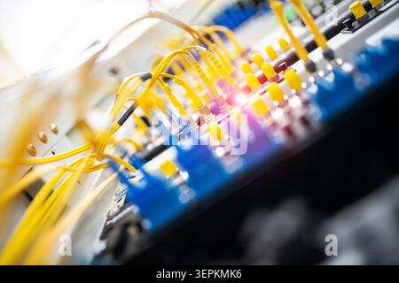 Fiber patch panel with connected optical cables in a server rack data center Stock Photo