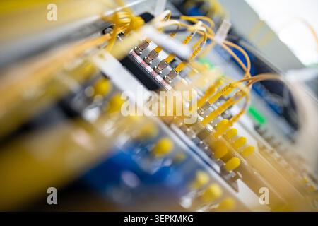 Fiber patch panel with connected optical cables in a server rack data center Stock Photo