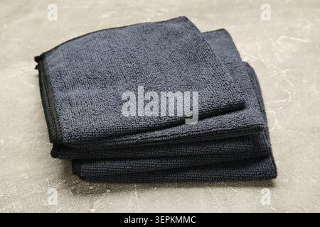 Microfiber cloth for cleaning and dusting on grey concrete background. Top view Stock Photo