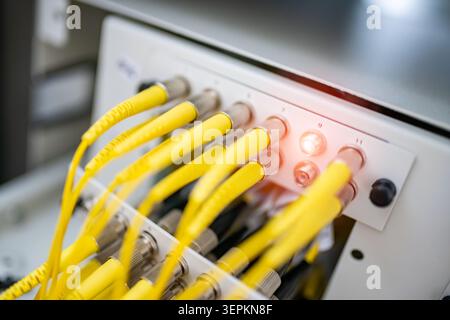Fiber patch panel with connected optical cables in a server rack data center Stock Photo