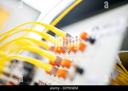 Fiber patch panel with connected optical cables in a server rack data center Stock Photo