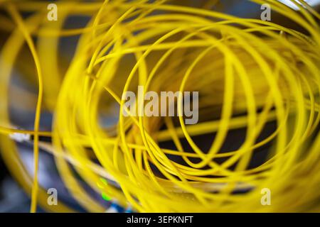 Fiber patch panel with connected optical cables in a server rack data center Stock Photo