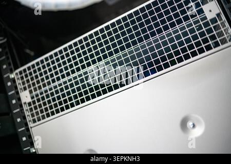 This close-up image showcases an advanced electronic ventilation system with a metal grill, components, and control elements, used for cooling and air Stock Photo