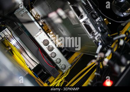 This image shows the inside of a server data center room with multiple servers, interconnected network cables, and cooling systems, emphasizing techno Stock Photo