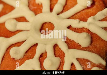 Assorted holiday cookies featuring birds, hearts, and gingerbread figures cover painted wooden boards. Vibrant icing and sprinkles provide cheerful vi Stock Photo