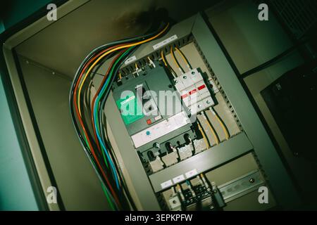 This image features an open electrical circuit breaker panel showcasing various wiring, switches, and safety components essential for electrical distr Stock Photo