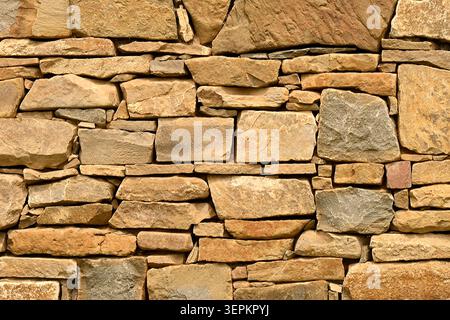 Rustic stacked stone wall background Stock Photo