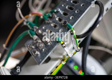 Close-up of an electronic circuit board with wires and connectors connected, showing detailed wiring and metallic components used in electronic system Stock Photo