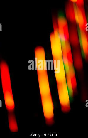 Neon colorful glow on a black backdrop. Iridescent neon background with light effect. Stock Photo