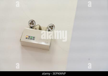 This image shows a modern electrical outlet with two power sockets mounted on a plain white wall, highlighting household electrical infrastructure and Stock Photo