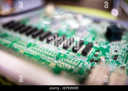 A detailed close-up image of a circuit board showcasing electronic components, connectors, and microchips. This photo highlights modern technology and Stock Photo