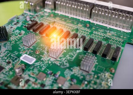 Close-up image of a computer circuit board featuring various electronic components, chips, and LEDs, illustrating the complexity of modern electronic Stock Photo