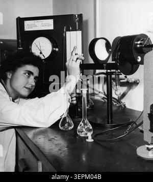 A young woman performing an experiment at the peat science laboratory at the higher school of rural economy in warsaw, poland may 1964, there are now more than three times more academic schools than before the war, the number of scientific research workers increased five-fold while the number of first year students in the academic year 1963/64 is far greater than the total number of students in all years of studies in all polish academic schools in the last pre-war year. Stock Photo